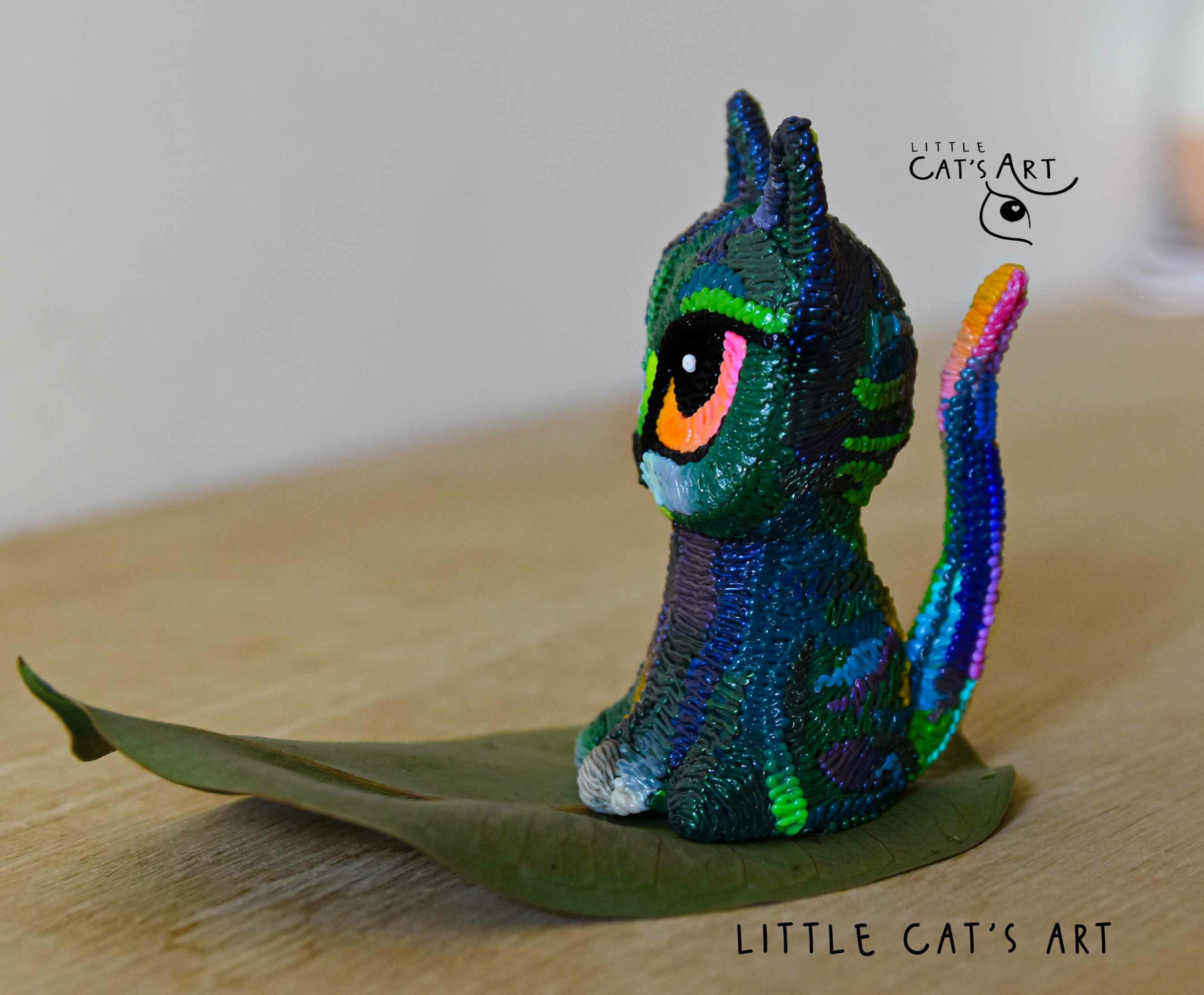 Iridescent green & purple cat figurine