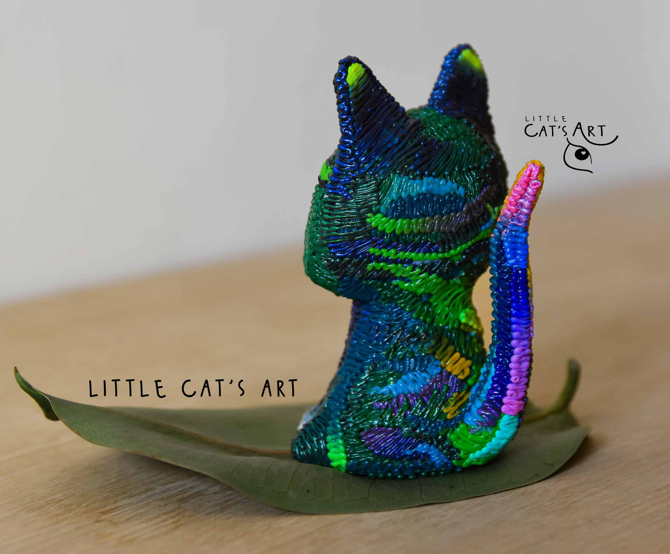 Iridescent green & purple cat figurine