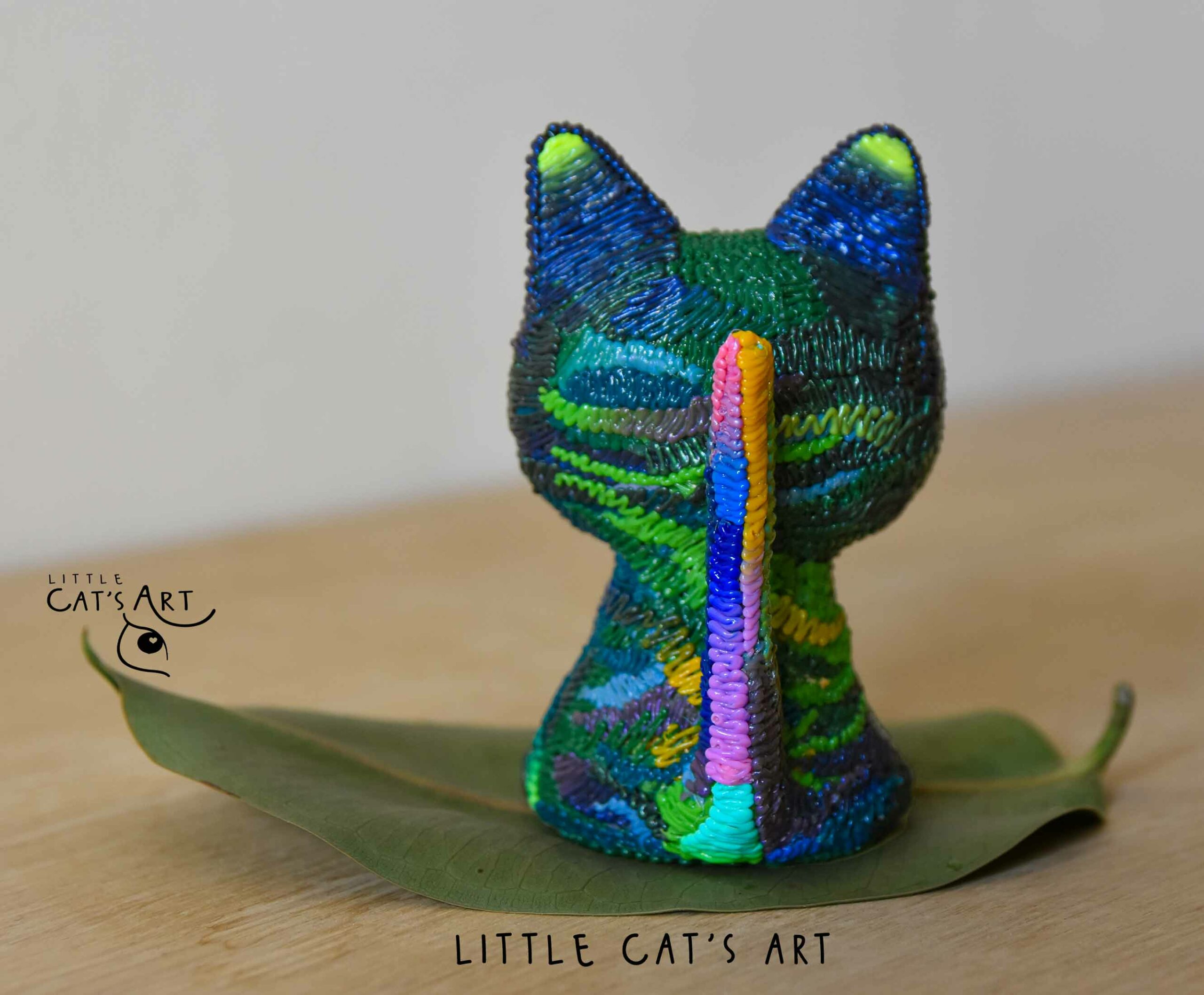 Iridescent green & purple cat figurine