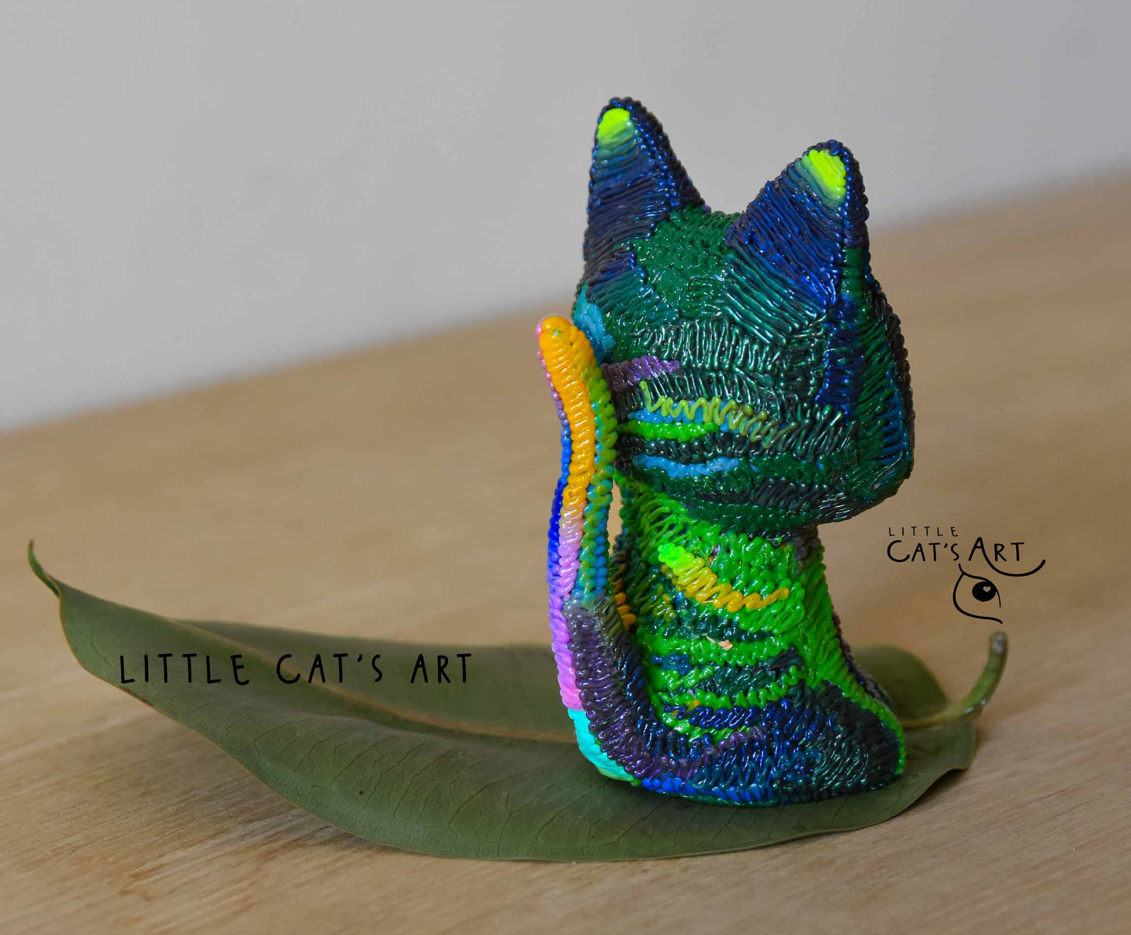Iridescent green & purple cat figurine