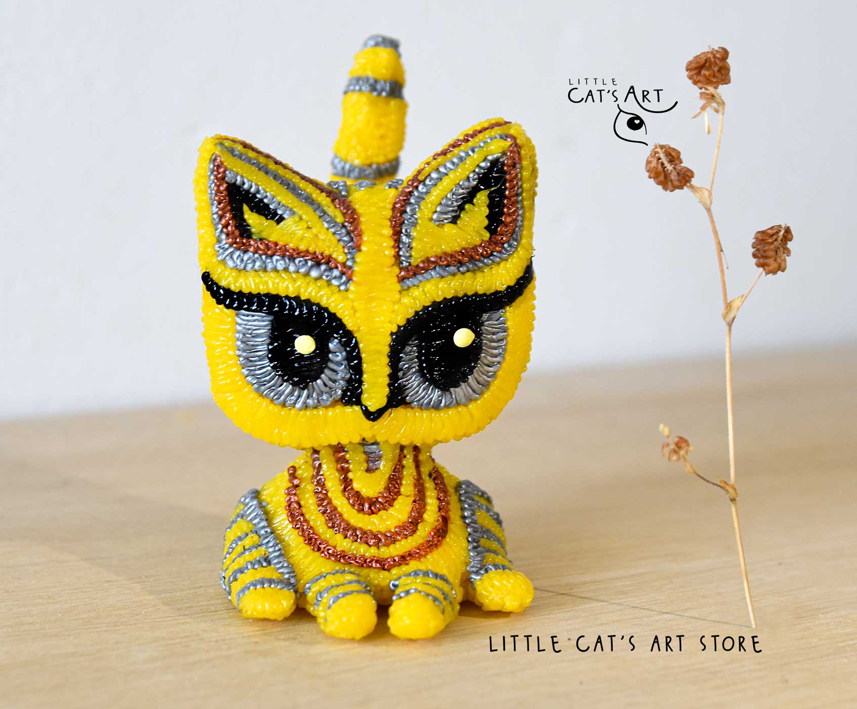 Yellow cat figurine with stripes