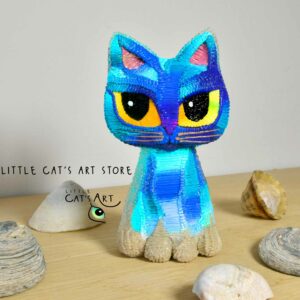 Blue and turquoise cat figurine with yellow eyes and sandy paws