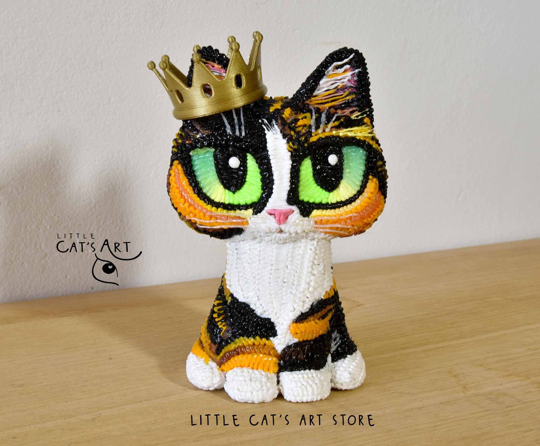 Mini me calico cat figurine wearing crown