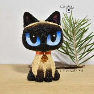 Siamese cat figurine with big blue eyes and red necklace