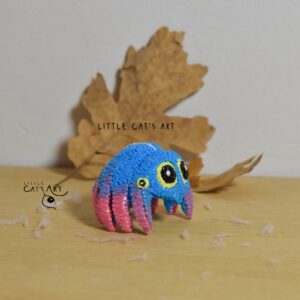 Little blue-pink spidey figurine with yellow eyes