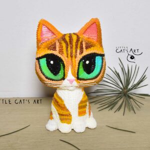 Ginger and white cat figurine with green-blue eyes